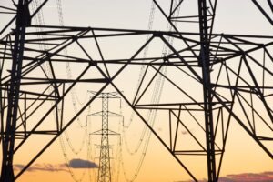 Power line tower. Energy industry. Industrial electricity distribution. Renewable production