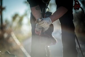 Solar panel installation worker with drill